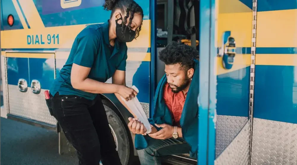 Man receiving leg bandage after injury, emphasizing the need for care and potential legal advice