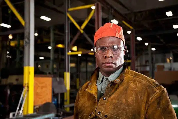 Chicago Labor Lawyer Representing Workers, an image of an African American worker in a fabrication shop wearing an orange cap, highlighting Disparti Law Group Accident & Injury Lawyers' commitment to worker rights