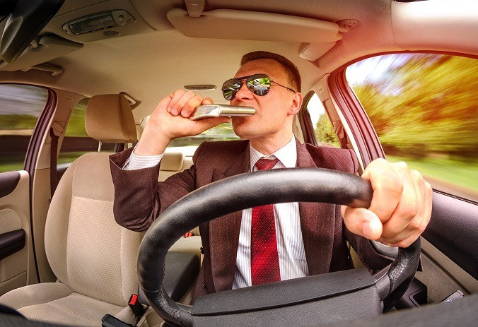 man drinking while driving