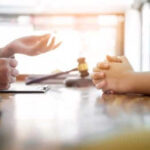 Irvine auto accident lawyer meeting with a client to discuss their case.