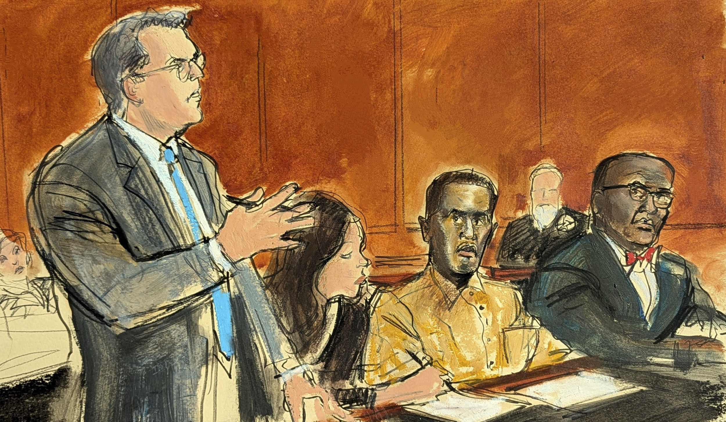 In this courtroom sketch, Sean "Diddy" Combs' defense attorney Marc Agnifilo, left, addresses the judge while Combs, seated second from right, in prison uniform, watches during a hearing in federal court in New York on...