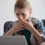 Teenage girl shocked by online content, highlighting the dangers of the internet and doxing