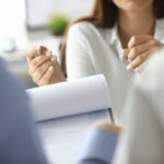 A woman discussing a document with two people
