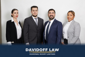 Smiling lawyer shaking hands with client, representing contact with Davidoff Law