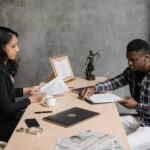 An attorney meeting with her client in her office.