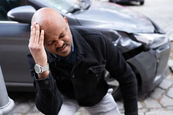 Man experiencing neck and back pain following an accident, highlighting common injuries in personal injury cases