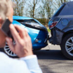 Woman talking on the phone after car accident in Lafayette, Louisiana