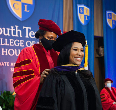Diverse students learning from a professor in a classroom setting