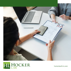An immigration lawyers handing important documents pertaining to a visa over to a client
