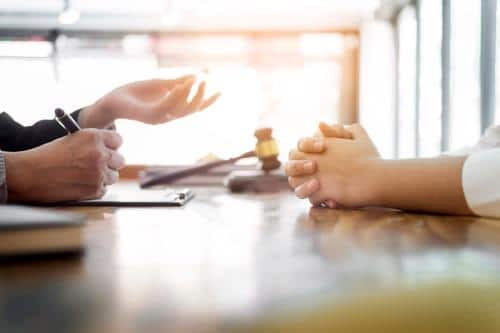 Irvine car accident attorney discussing a case with a client in an office setting.