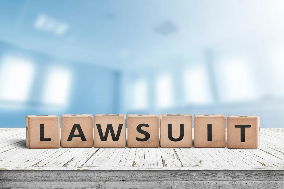 lawsuit spelled out in toy blocks.