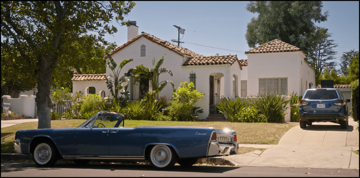 Manuel Garcia-Rulfo as Mickey Haller standing next to the 1963 Lincoln Continental convertible in The Lincoln Lawyer