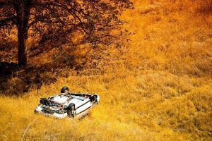 A car flipped over after a car wreck, highlighting the need for a car wreck lawyer in Louisville.