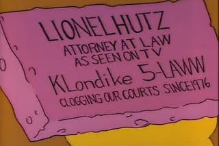 Lionel Hutz's sponge business card with slogans "As seen on TV" and "Clogging our courts since 1976"