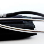 Medical professional using a stethoscope to listen to a patient's heartbeat, symbolizing medical attention and personal injury cases.