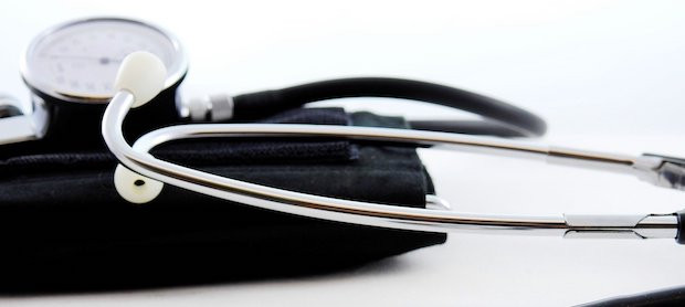 Medical professional using a stethoscope to listen to a patient's heartbeat, symbolizing medical attention and personal injury cases.
