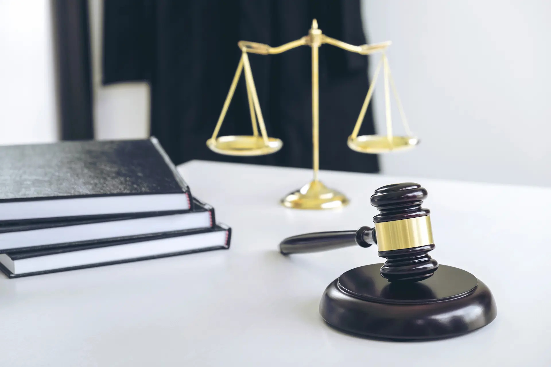 A gavel and law books symbolizing the legal profession and the distinction between an attorney who can represent clients in court and a lawyer with a broader legal education and expertise.