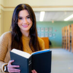 Haley Clark smiles warmly against a blurred background.