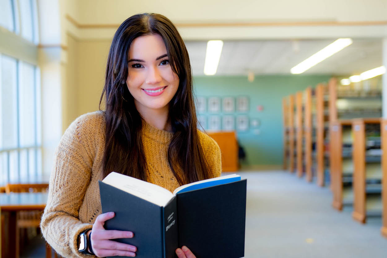 Haley Clark smiles warmly against a blurred background.